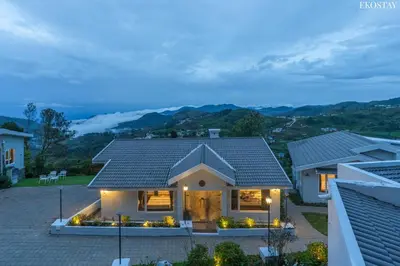 a house with a view of the mountains at EKOSTAY - Skyfall Cloud 9 Villa in Ooty