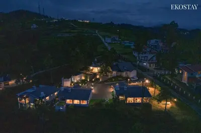 a view of a house at night with lights at EKOSTAY - Skyfall Elysium Villa in Ooty