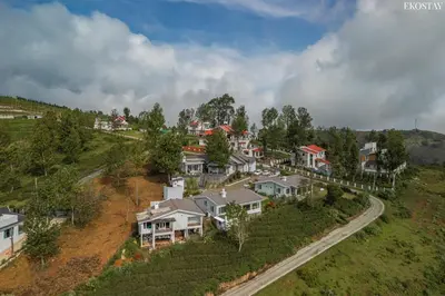 an aerial view of a houses in a hill at EKOSTAY - Skyfall Elysium Villa in Ooty