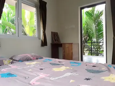 a bed with decorations on it in a bedroom at SriMahi Farmhouse in Agali