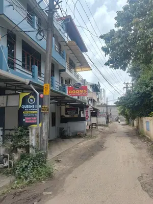 an empty street in front of a building at Queens INN in Kodungallūr