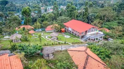 an aerial view of a house with a red roof at Zacs Valley Resort & Wellness Retreat Kodaikanal in Kodaikānāl