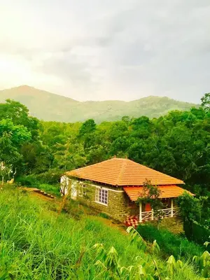 a house with an orange roof on top of a hill at Zacs Valley Resort & Wellness Retreat Kodaikanal in Kodaikānāl