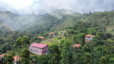 a building in the middle of a mountain at Zacs Valley Resort & Wellness Retreat Kodaikanal in Kodaikānāl