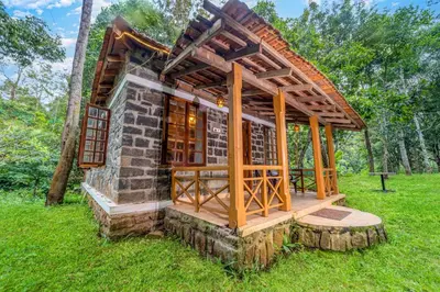 a small building in a field of grass at Zacs Valley Resort & Wellness Retreat Kodaikanal in Kodaikānāl