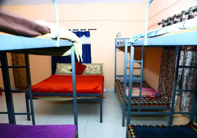 a room with two bunk beds and a couch at JJ Homes in Ooty