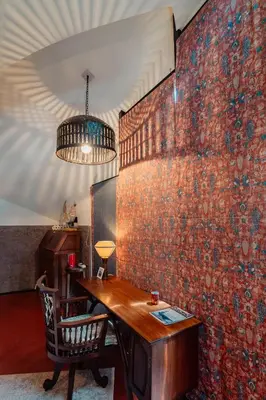 a room with a table and a brick wall at Madilina Cottage in Parūr