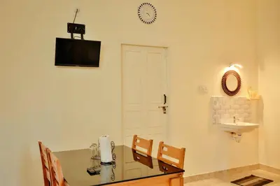 a room with a table and chairs and a sink at Akasha Nila Heavens 2 BHK Homestay - Top floor in Guruvāyūr