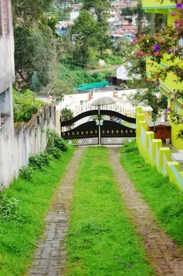 a view of a bridge over a field of grass at Winterfell Park in Ooty