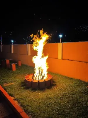 a fire pit in the grass at night at Winterfell Park in Ooty