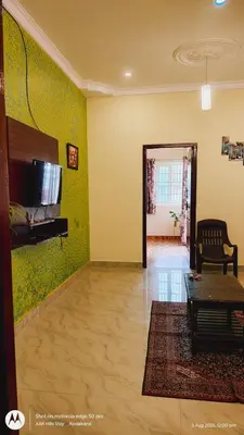 a living room with green walls and a couch and a table at AAK Hills stay villa in Kodaikānāl