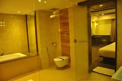 a bathroom with a toilet and a shower and a sink at Hotel Atrium in Erode