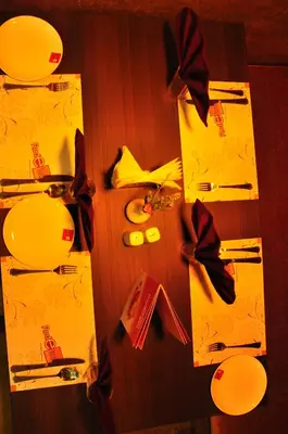 a table topped with yellow wrapping paper and bows at Hotel Atrium in Erode