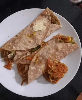 a white plate with threeangularangularangularangular at Puthooram Veedu in Chakkarakkal