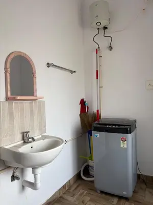 a bathroom with a sink and a mirror at Anchery homes in Trichūr