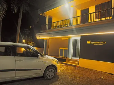 a car parked in front of a building at night at Clap House Home in Guruvāyūr