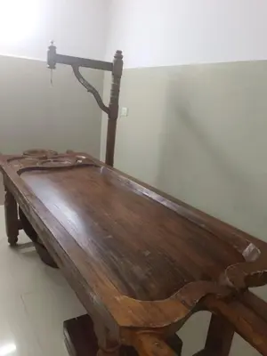 a wooden bench sitting in the corner of a room at Kerala Ayurveda and yoga for women sn in Ernakulam