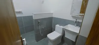 a bathroom with a toilet and a sink at Alanchery Residency in Cheruthuruthi