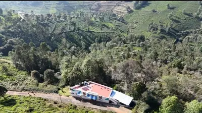 a train on a track in the middle of a mountain at The Wild House in Kotagiri