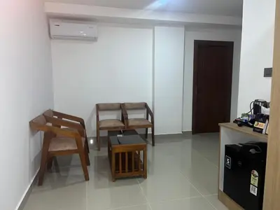 a room with chairs and a table and a door at Hotel Queen Maria in Kizhillam