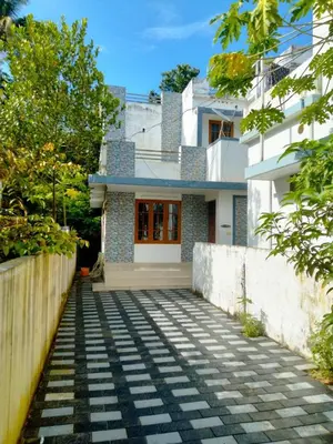 a house with a walkway in front of it at Peaceful Vacation Home Near the City in Cochin