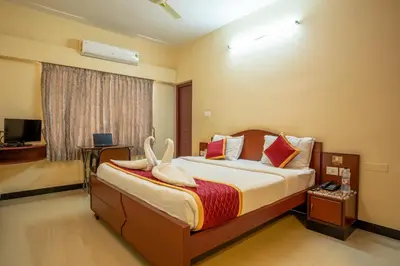 a bedroom with a bed with towels on it at MK Residency in Coimbatore