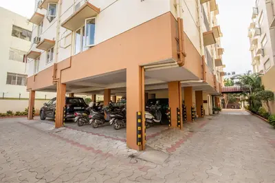a building with motorcycles parked outside of it at MK Residency in Coimbatore