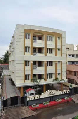 a large apartment building in front of a building at MK Residency in Coimbatore
