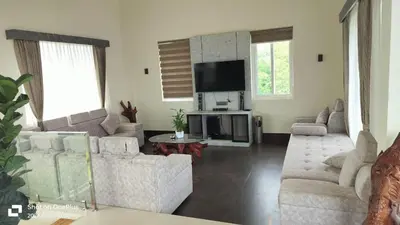 a living room with couches and a flat screen tv at Coorg Riverness Resort in Kushālnagar
