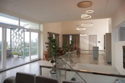 a large room with a bath tub and a staircase at Coorg Riverness Resort in Kushālnagar