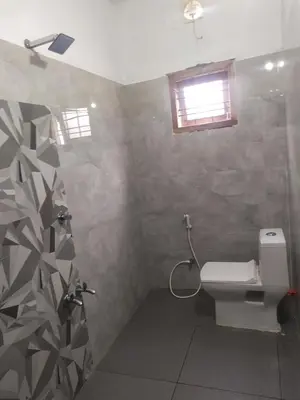 a bathroom with a shower and a toilet in it at Munnar Mountain view cottage in Munnar