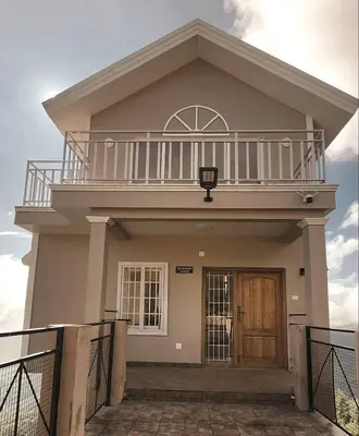 a large house with a balcony on top of it at The Ark Haven Ooty by Scenic Serenity Stays in Ketti