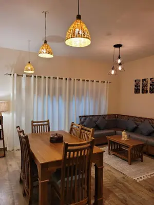 a living room with a table and a couch at The Ark Haven Ooty by Scenic Serenity Stays in Ketti