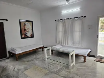a room with two beds and a glass table at Shiva Shambo Home Stay - Entire Villa in Coimbatore