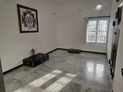 an empty room with a large white room with a table at Shiva Shambo Home Stay - Entire Villa in Coimbatore