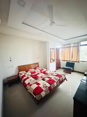 a bedroom with a large bed and a couch at Fully furnished 2BHK apartment near Gokulam in Mysore