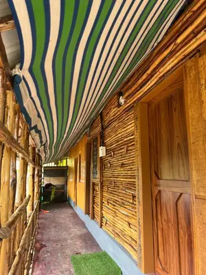 a hallway of a house with a striped ceiling at Kovilakam in Vattavada