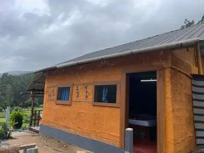 a small house with a door and a window at Kovilakam in Vattavada