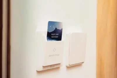 a refrigerator with a book on the side of it at Dubai Frame Residency And Hotel in Thottada