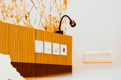 a lightswitch on a wooden wall in a bedroom at Dubai Frame Residency And Hotel in Thottada