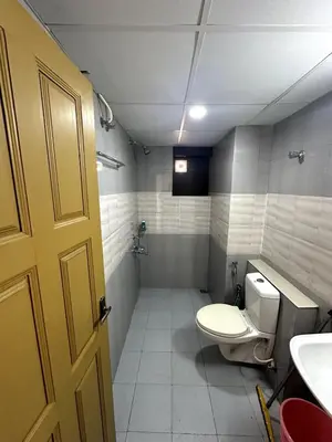 a bathroom with a toilet and a sink at Ocean View 4 BHK Apartment in Kannur
