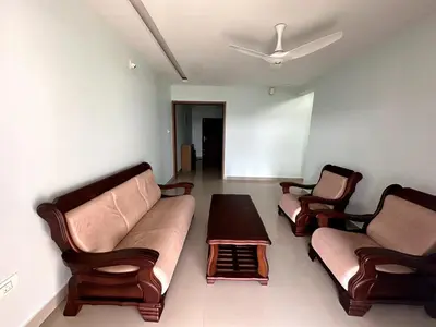 a living room with two couches and a table at Ocean View 4 BHK Apartment in Kannur