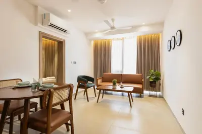 a living room with a table and a couch at Altin Stays in Coimbatore