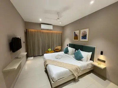 a bedroom with a large bed and a window at Altin Stays in Coimbatore