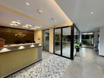 a lobby of a store with a counter and glass doors at Altin Stays in Coimbatore
