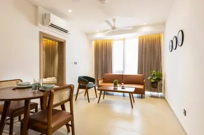 a living room with a table and a couch at Altin Stays in Coimbatore