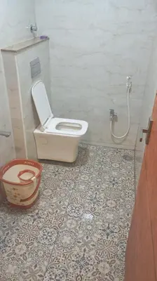 a bathroom with a toilet and a bucket at Hotel Maharajas in Kāmānayakkanpālaiyam