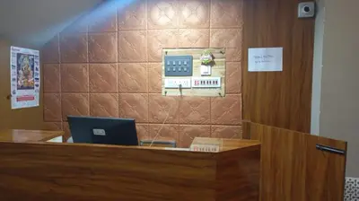 an office with a desk with a laptop on it at Hotel Maharajas in Kāmānayakkanpālaiyam