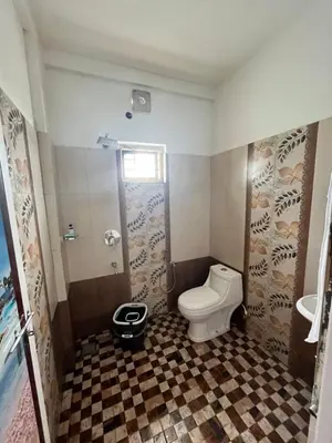 a bathroom with a toilet and a sink at SREE CHAKRA Tourist Home Guruvayoor in Guruvāyūr