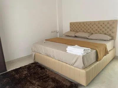 a bedroom with a large bed with towels on it at SREE CHAKRA Tourist Home Guruvayoor in Guruvāyūr